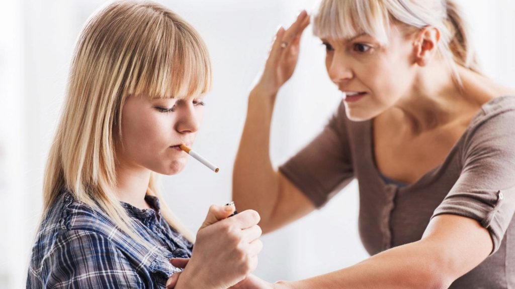 woman is stressed over a young girl smoking